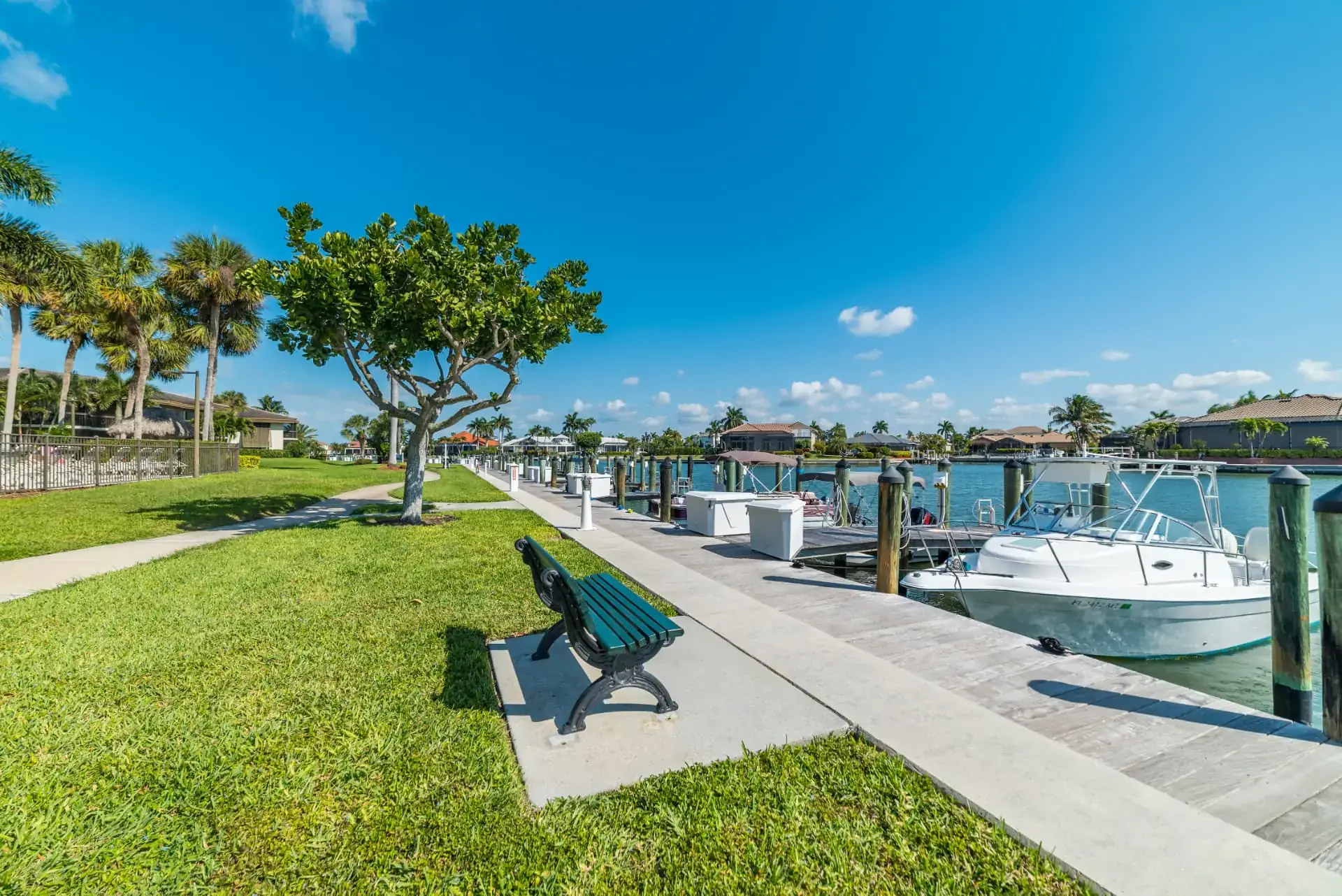 South Seas waterfront walkway with boat docks and moored boats on the Marco Island waterway